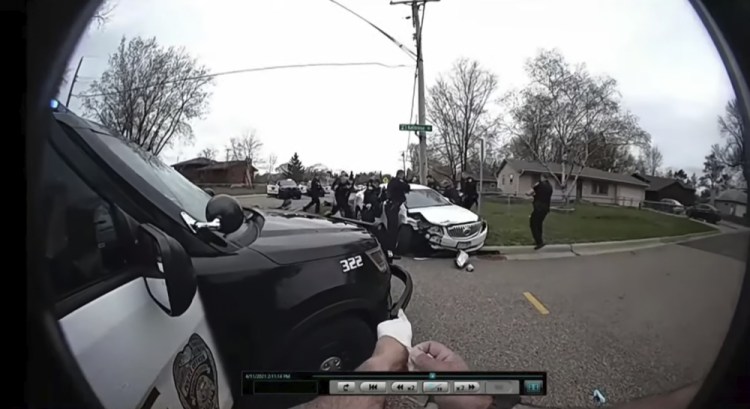 In this image taken from Brooklyn Center Police Officer Jeffrey Sommers' body cam video that was played during the trial of former Brooklyn Center police Officer Kim Potter on Thursday in Minneapolis, police approach the car that Daunte Wright was driving after being shot during a traffic stop. Potter, who is white, is charged with first- and second-degree manslaughter in the shooting. She has said she meant to use her Taser – but grabbed her handgun instead – after Wright tried to drive away as officers were trying to arrest him. 