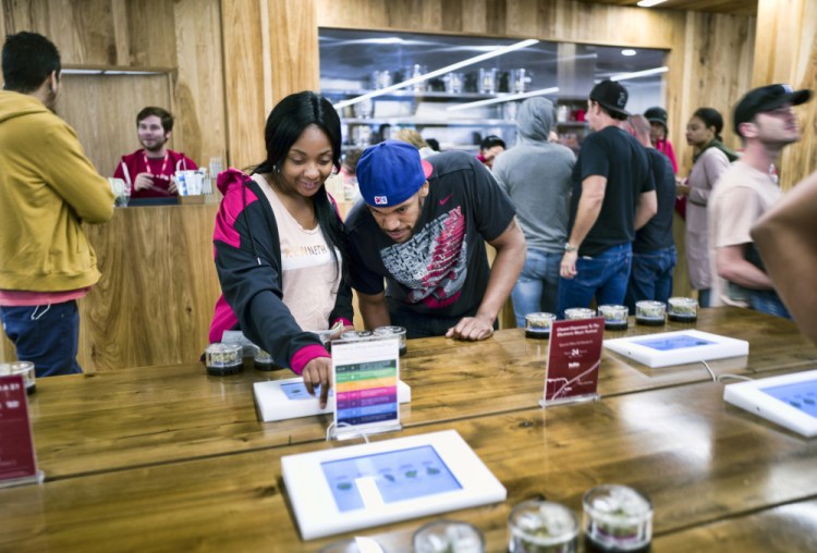 Tourists Randy Wilkie and Keya Cole of Buffalo, New York, check out the offerings at one of the MedMen cannabis dispensaries in Los Angeles in 2018. 
