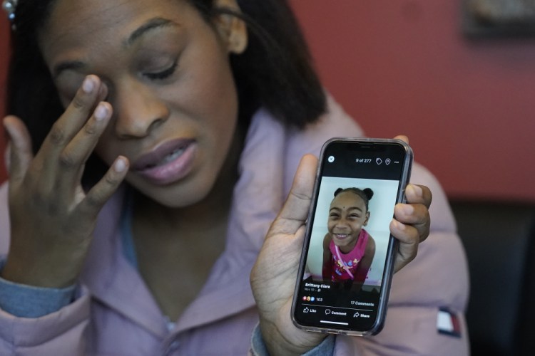 Brittany Tichenor-Cox, holds a photo of her daughter, Isabella "Izzy" Tichenor, during an interview Monday in Draper, Utah. Tichenor-Cox said her 10-year-old daughter died by suicide after she was harassed for being Black and autistic at school. She is speaking out about the school not doing enough to stop the bullying.