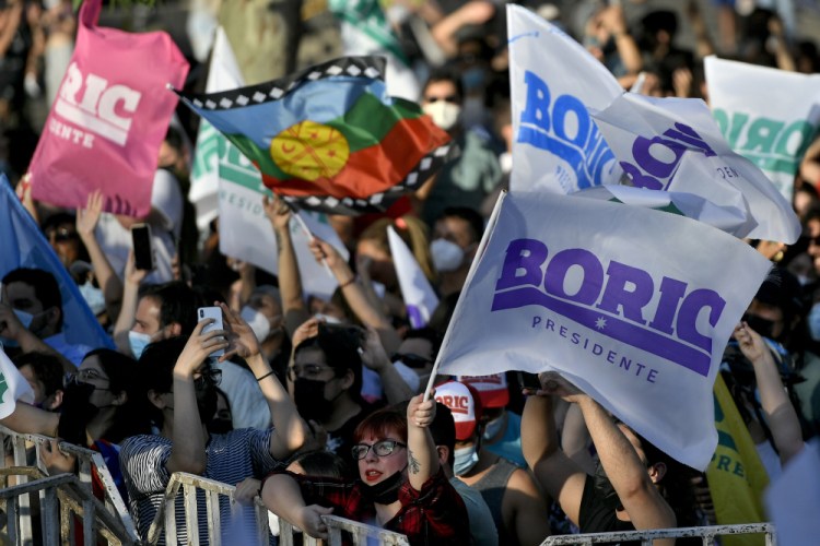 Supporters of Gabriel Boric, of the "I Approve Dignity" coalition, gather at his election day headquarters after polls closed and partial results were announced in Santiago, Chile, on Sunday.

