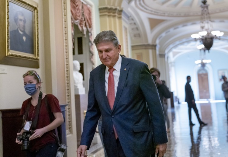 Sen. Joe Manchin, D-W.Va., a centrist Democrat vital to the fate of President Joe Biden's $3.5 government overhaul, walks to a caucus lunch at the Capitol on Friday. 