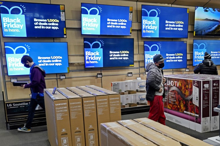 People look at televisions during a Black Friday sale at a Best Buy store in November in Overland Park, Kan. Prices for U.S. consumers jumped 6.8% in November compared with a year earlier. 