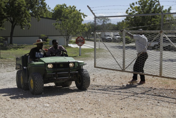 Workers ride out of the gate of the Christian Aid Ministries headquarters in Titanyen, north of Port-au-Prince, Haiti, this month. All of the group's members who were kidnapped two months ago have been freed, the group said Thusday. 