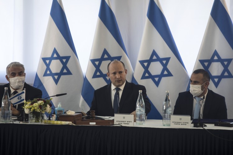 Israeli Prime Minister Naftali Bennett, center, speaks at the weekly cabinet meeting in Kibbutz Mevo Hama, in the Israeli-occupied Golan Heights, Sunday.