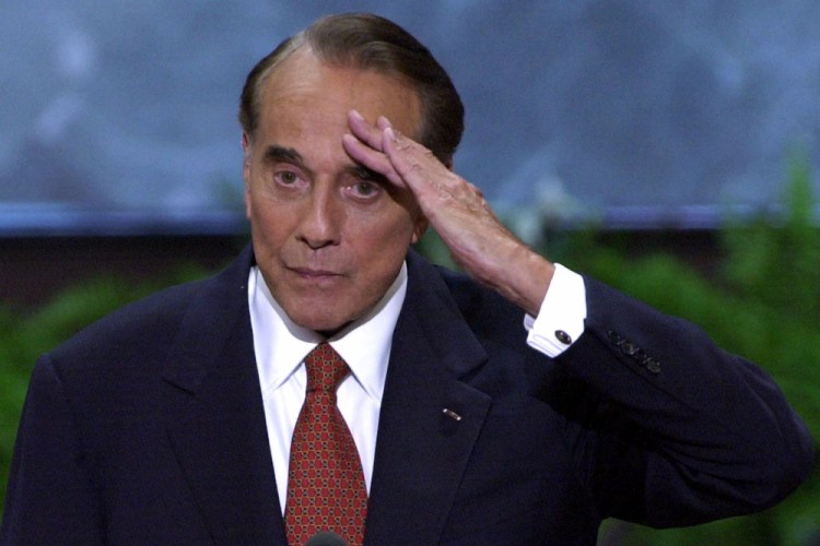 FILE - In this Aug. 1, 2000, file photo, former senator and former presidential candidate Bob Dole salutes after a speech at the Republican National Convention in the First Union Center in Philadelphia. Bob Dole, who overcame disabling war wounds to become a sharp-tongued Senate leader from Kansas, a Republican presidential candidate and then a symbol and celebrant of his dwindling generation of World War II veterans, has died. He was 98. His wife, Elizabeth Dole, posted the announcement Sunday, Dec. 5, 2021, on Twitter. (AP Photo/Ron Edmonds, File)