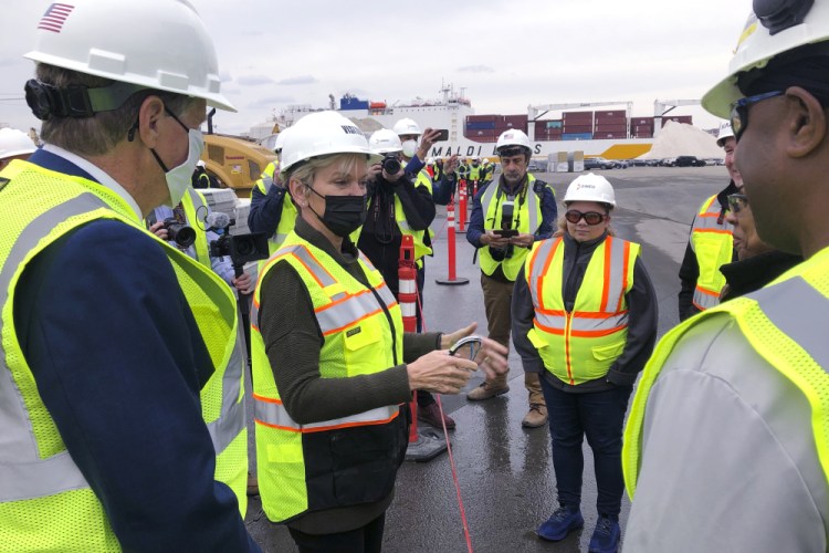 U.S. Energy Secretary Jennifer Granholm, center, speaks with workers, and Rhode Island Gov. Dan McKee, left, on Thursday while visiting an under-construction fabrication and assembly facility for offshore wind turbines at the Port of Providence, in Providence, R.I. The building is scheduled to be finished this spring to support two offshore wind projects, Revolution Wind and South Fork Wind. 