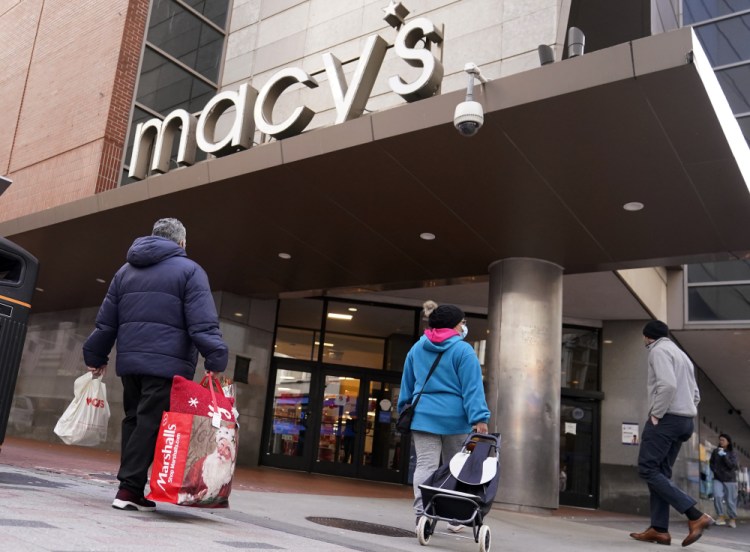 Shoppers walk to the Macy's store in the Downtown Crossing district on Nov. 17  in Boston. 

