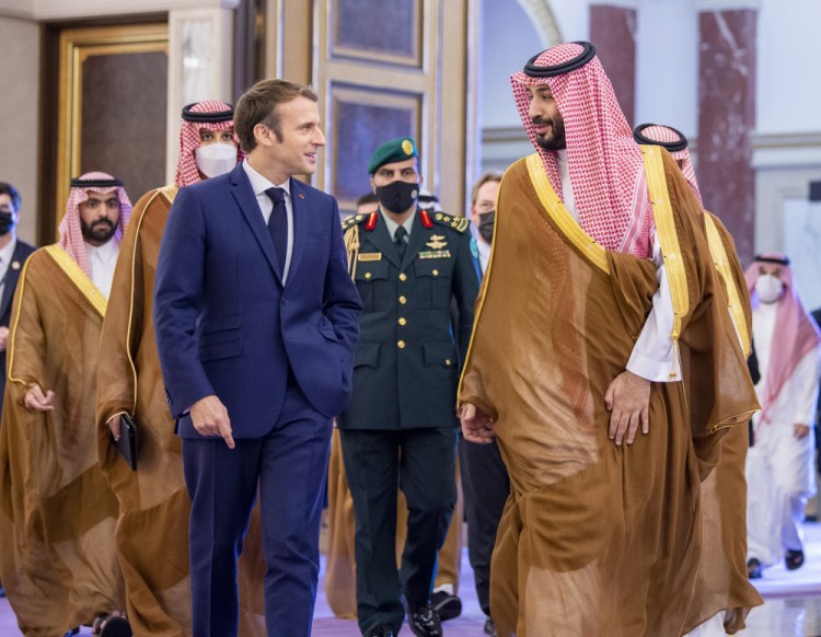 Saudi Crown Prince Mohammed bin Salman greets French President Emmanuel Macron, left, upon his arrival in Jiddah on Saturday. 