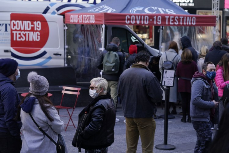 People wait in line at a COVID-19 testing site in Times Square, New York, on Monday. 