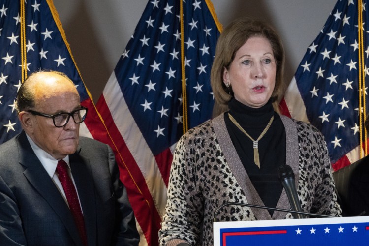 Sidney Powell, right, speaks next to former Mayor of New York Rudy Giuliani, as members of President Donald Trump's legal team, during a news conference at the Republican National Committee headquarters on Nov. 19, 2020, in Washington. 