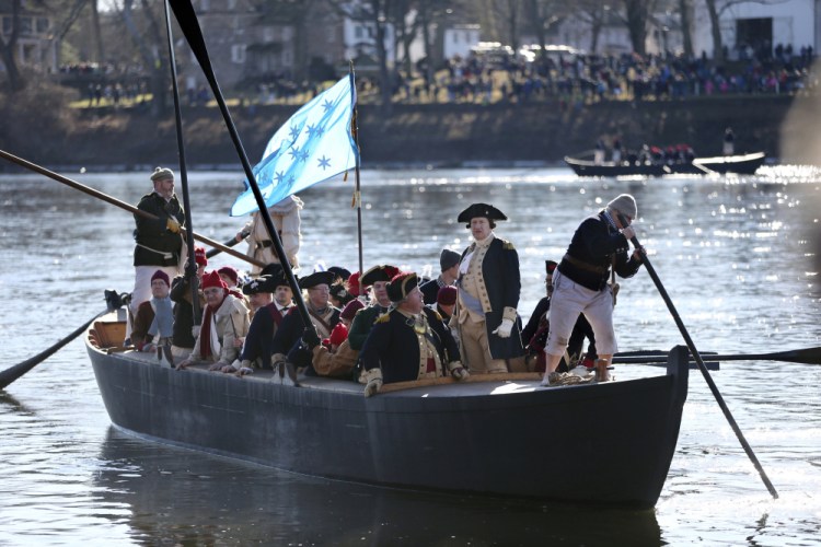 John Godzieba, as Gen. George Washington, second right, stands in a boat during a re-enactment of Washington's daring Christmas 1776 crossing of the Delaware River in Washington Crossing, Pa., on Saturday. 