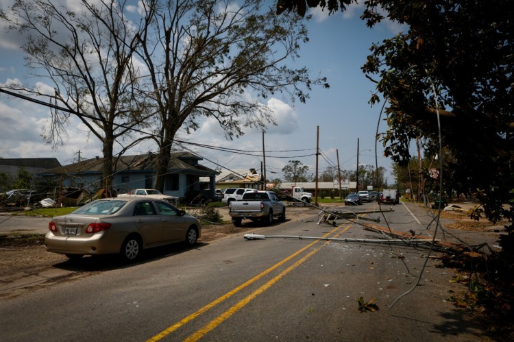 Utility poles and street lamps lay across a street after Hurricane Ida damaged Laplace, La., on Sept. 2, 2021. MUST CREDIT: Bloomberg photo by Eva Marie Uzcategui