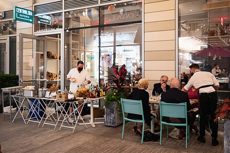 The outdoor dining area at Centrolina restaurant at City Place in downtown Washington, D.C., includes an outdoor bar for diners and passersby. 