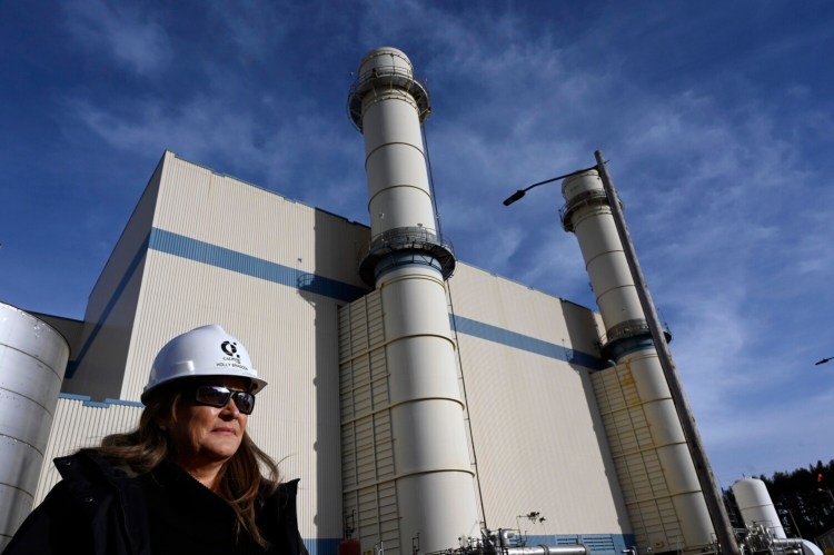 Plant Manager Holly Bragdon stands in front of Calpine Corp.'s Westbrook Energy Center natural gas-fired power plant on Dec. 7. Natural gas remains an essential component of New England's energy mix despite its contribution to global warming.