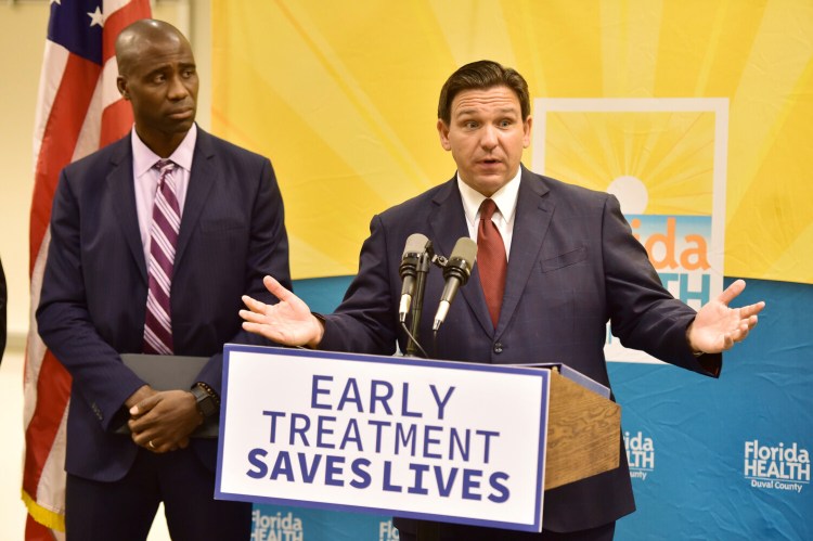Florida Gov. Ron DeSantis addresses the media with Dr. Joseph Ladapo, Florida surgeon general, during a news conference in Jacksonville, Fla., on Tuesday to discuss COVID-19 testing policy and monoclonal antibody treatment availability. DeSantis, one of the most vocal proponents of monoclonal antibody treatments, said his state would soon receive an additional 30,000 doses.