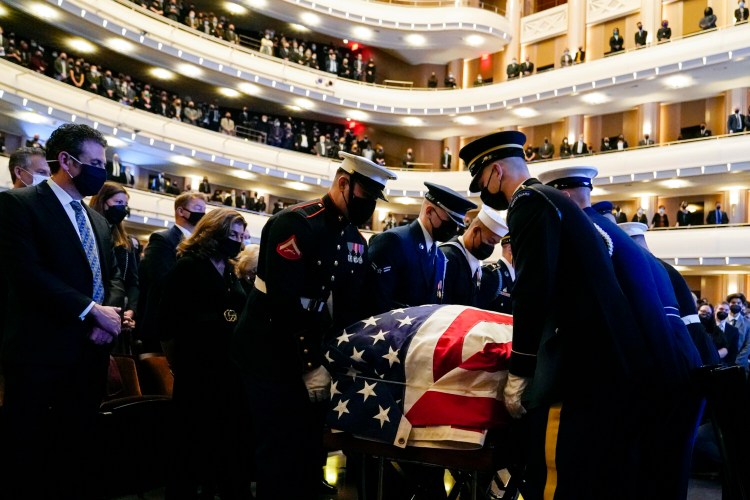 A military honor guard moves the flag-draped casket of former Senate Majority Leader Harry Reid during a memorial service Saturday at the Smith Center in Las Vegas.