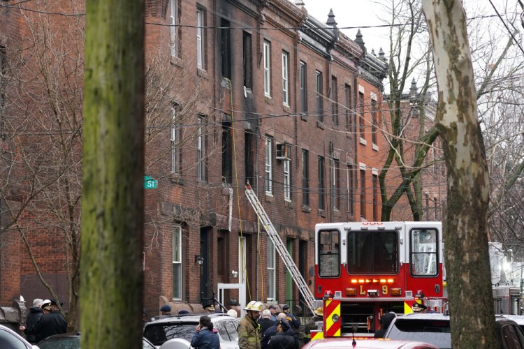 Philadelphia firefighters work at the scene of a deadly row house fire on Wednesday in the Fairmount neighborhood of Philadelphia. 