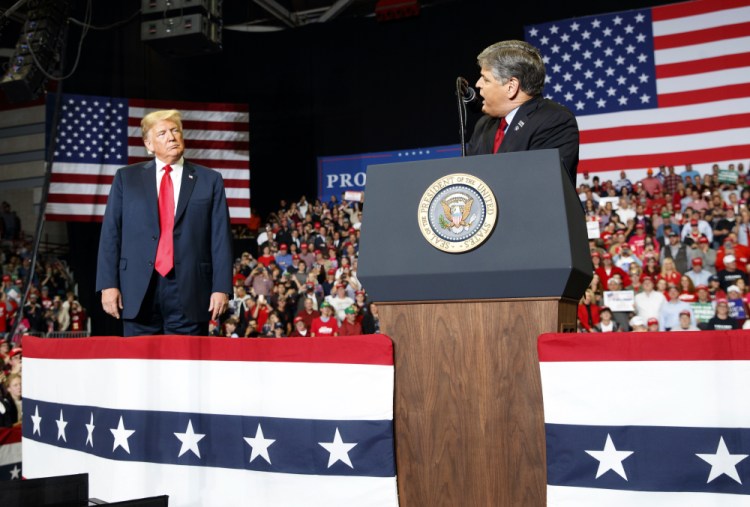 President Trump listens to Fox News' Sean Hannity at a rally in  2018 in Cape Girardeau, Mo. 

