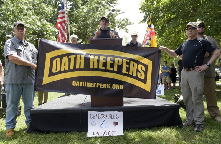 Stewart Rhodes, founder of the citizen militia group known as the Oath Keepers, center, speaks during a rally outside the White House in Washington, on June 25, 2017. 