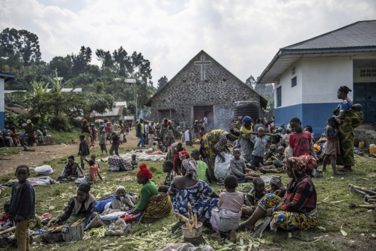 People fleeing the fighting between M23 forces and the Congolese army find refuge in a church in Kibumba, north of Goma, on Friday.


