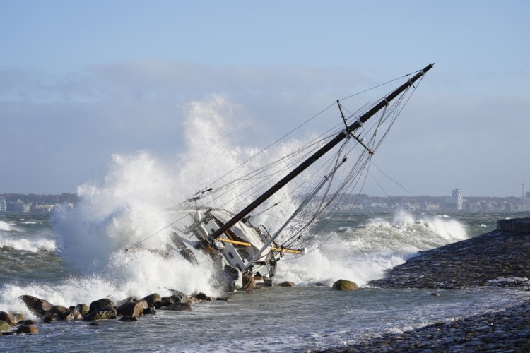 Waves crash against a sailboat in Elsinore, Denmark, Sunday after a large winter storm caused havoc in Scandinavia.