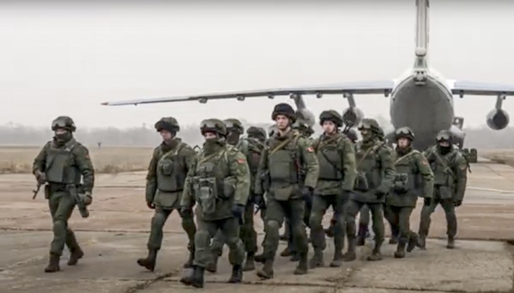 Belarusian peacekeepers leave a Russian military plane at an airfield in Kazakhstan on  Saturday.

