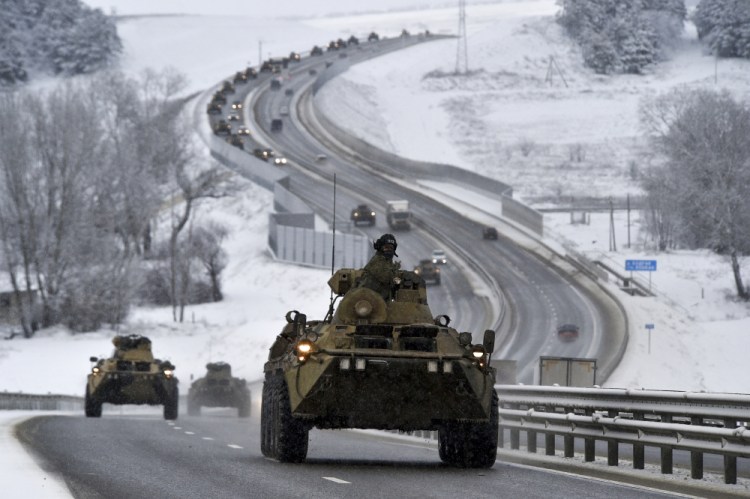 A convoy of Russian armored vehicles moves along a highway in Crimea on Tuesday. Russia has concentrated an estimated 100,000 troops with tanks and other heavy weapons near Ukraine in what the West fears could be a prelude to an invasion. 