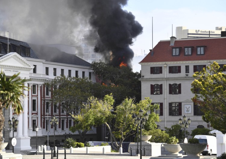 A fire burns at the Houses of Parliament, in Cape Town, South Africa. The country's minister of public works and infrastructure said Sunday's fire started on the third floor of a building that houses offices and spread to the National Assembly building, where South Africa's Parliament sits.