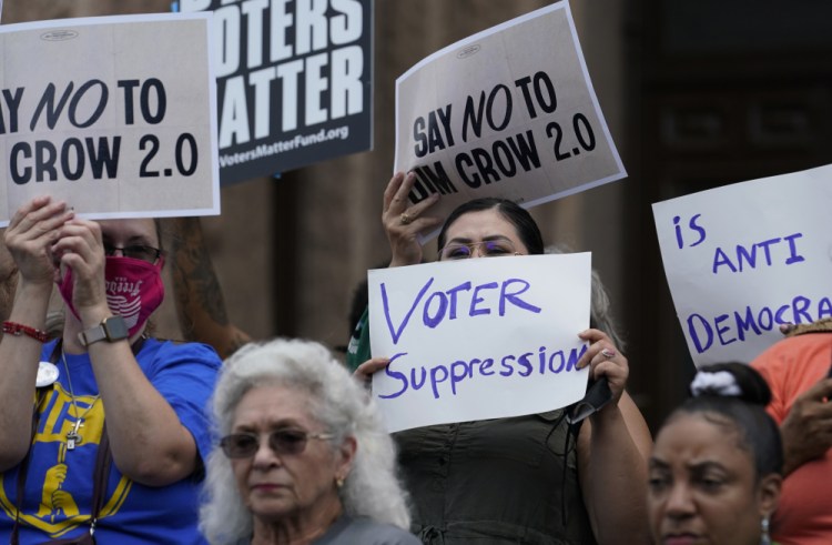 Demonstrators protest Republican-backed voting bills in July on the steps of the Texas Capitol in Austin. The sweeping new law is drawing fire again.