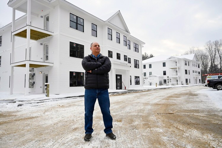 Auburn Mayor Jason Levesque stands outside West Shore Landing, a new complex that added 36 apartments toward his goal to help create 2,000 housing units in Auburn by 2025.
