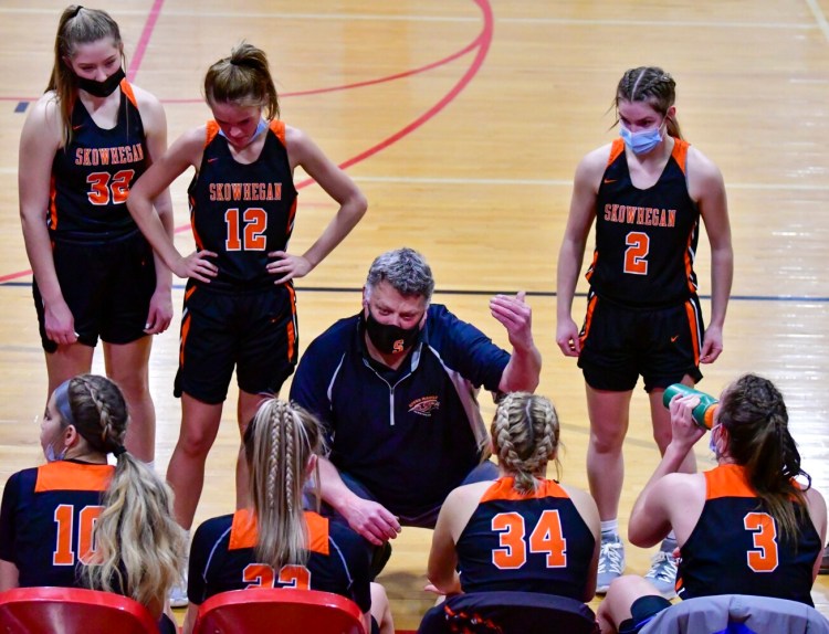AUGUSTA, ME - FEBRUARY 8:  Skowhegan bench huddles around head coach Mike LeBlanc during a timeout in a basketball game Tuesday February 8, 2022 in the Ryan Family Gym at Cony Middle and High School in Augusta.(Staff photo by Joe Phelan/Staff Photographer)