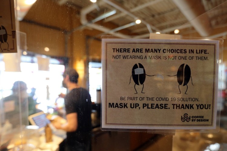  A sign spells out Portland's mask rule at Coffee by Design.