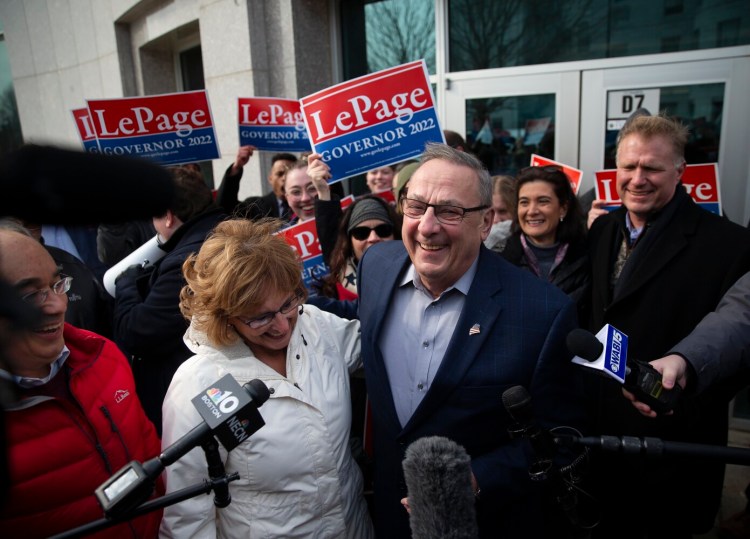 Former Gov. Paul LePage talks to the press after walking with his wife Ann to the State House to submit signatures to the Secretary of State to qualify and have his name placed on the 2022 ballot. 