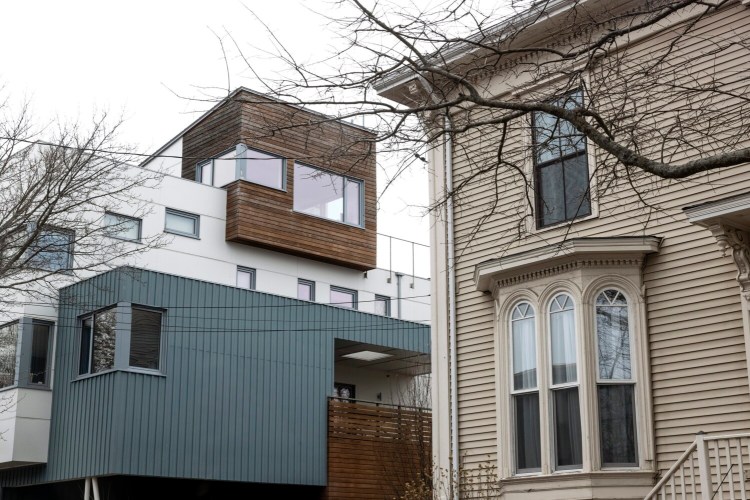A modern home and an older home stand side by side on Quebec Street on Munjoy Hill. "Clearly the development patterns are broken on Munjoy Hill," one resident told Portland's planning board Tuesday night.