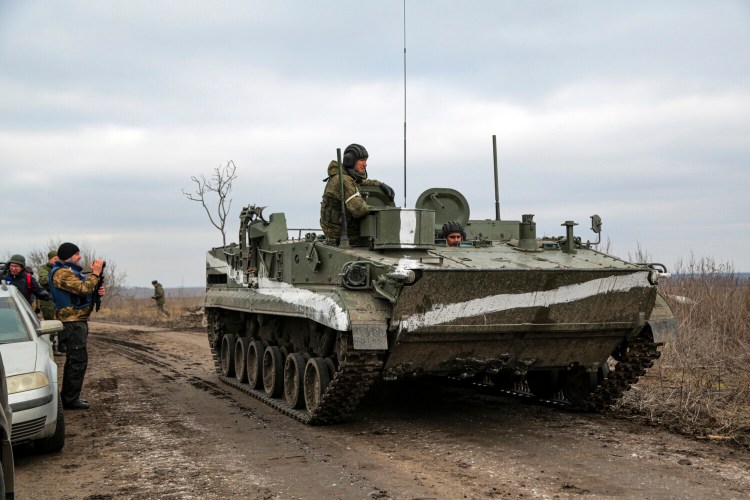 An armored vehicle rolls past a cameraman outside Mykolaivka, in Donetsk region, the territory controlled by pro-Russian militants, on Sunday. A senior U.S. defense officials says Russian troops  have yet to take control of any significant city or meaningful chunk of territory in Ukraine.