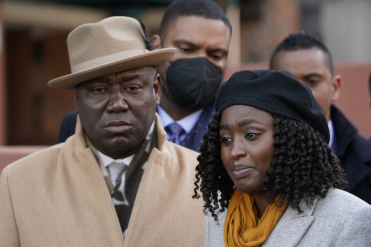 Attorney Ben Crump, left, looks on as Fatiah Touray, who had family that was killed in the Jan. 9 Bronx apartment building fire, speaks to reporters  Tuesday. “We may be Black and brown and African and immigrant, but we’re working class people, and we’re not fungible. We’re not disposable. You can’t just throw us away just because, you know, we have a certain socioeconomic status,” said Touray.