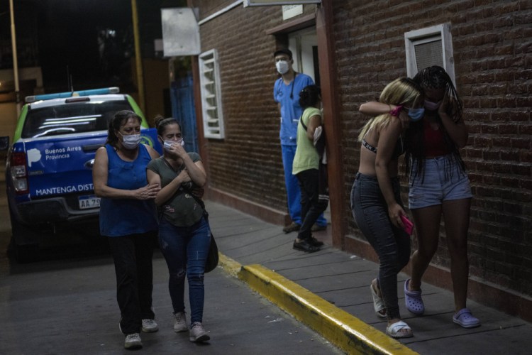 Relatives and friends of people who were poisoned with adulterated cocaine cry after talking to doctors outside the emergency room of a hospital in the outskirts of Buenos Aires, Argentina, on Wednesday.