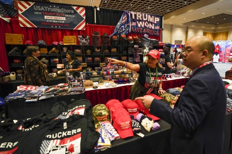Conference attendees shop for merchandise at a trade show at the Conservative Political Action Conference on Friday in Orlando, Fla.