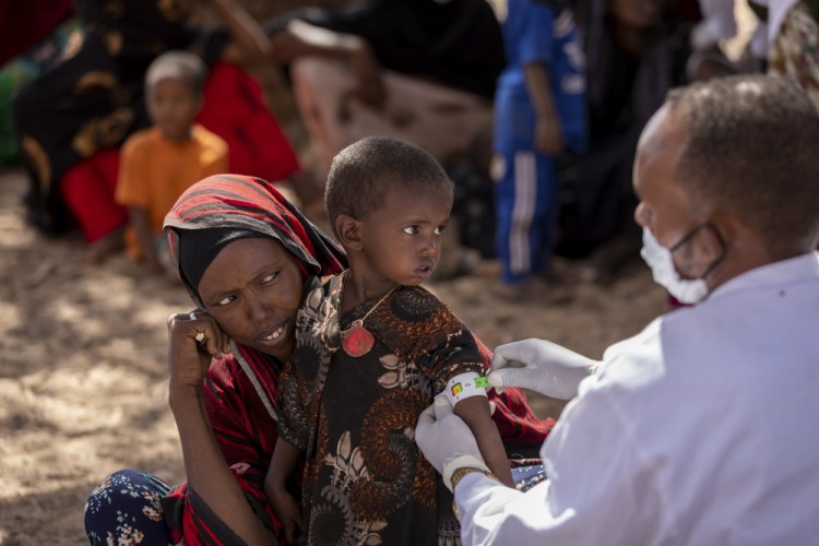 A nurse measures an arm of Nimo Abdi, who is suffering from diarrhea and vomiting and is receiving treatment for malnutrition, as she is held by her mother, Shamis Dhire, on Jan. 20 at a UNICEF-supported mobile clinic at Barare village in the Higloley Woreda of the Somali region of Ethiopia.

