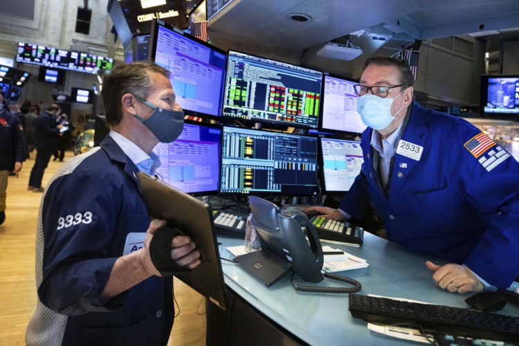 Trader Robert Charmak, left, and specialist Patrick King work on the floor of the New York Stock Exchange on Tuesday.

