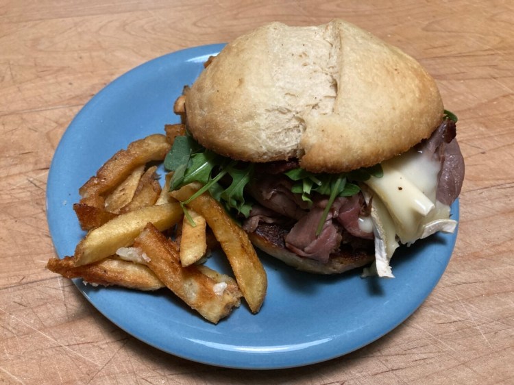 A sandwich of house roast beef, brie cheese, arugula, mushroom duxelle, fig and cranberry compote on a thyme butter bun, from Foulmouthed Brewing in South Portland. 