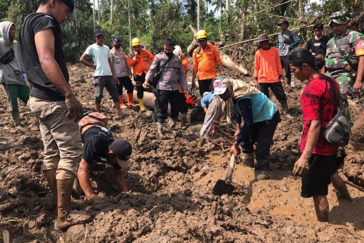 Rescuers search for the victims of an earthquake-triggered landslide in Pasaman, Indonesia, on Sunday.