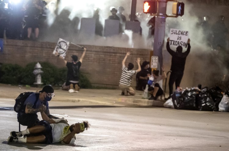 People help a protester who was shot with a rubber bullet in Austin, Texas, on May 30, 2020, while protesting the death of George Floyd.