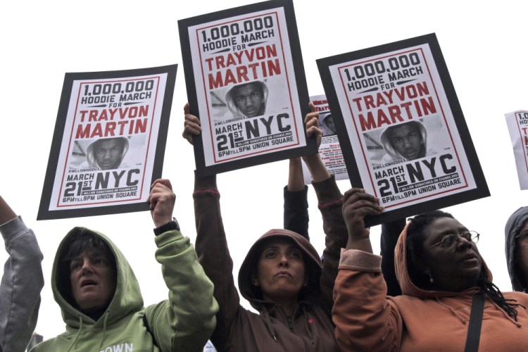 Demonstrators hold signs in support of Trayvon Martin in New York's Union Square in 2012.


