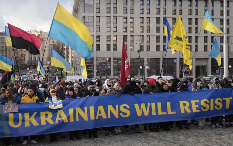 Ukrainians attend a rally in central Kyiv, Ukraine, Saturday during a protest against the potential escalation of the tension between Russia and Ukraine. Russian President Vladimir Putin and U.S. President Joe Biden are to hold a high-stakes telephone call on Saturday.