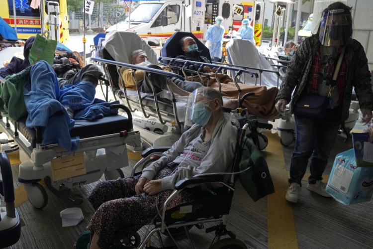 Patients wait at a temporary treatment area outside Caritas Medical Centre in Hong Kong on Saturday.