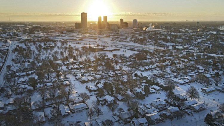 The sun rises over a snow-covered Tulsa, Okla., on Friday. 