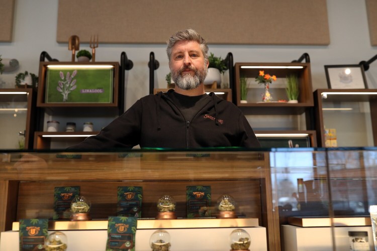 Jim Henry, CEO of Sweet Dirt, an Eliot-based cannabis company, stands by a display of cannabis flower at his Portland location. Sweet Dirt alleges that the way Kittery set up the lottery for scarce marijuana business licenses allowed it to be easily gamed by savvy businesses that could afford to pay for hundreds of entries.