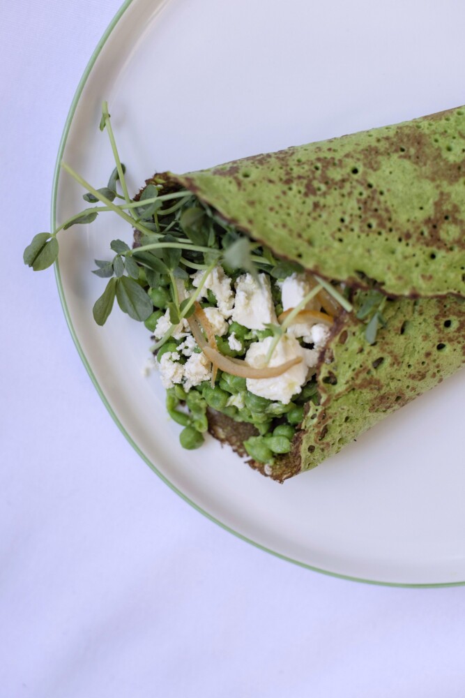 A spinach and chickpea flour crepe filled with mushy peas, preserved lemons, feta (from Toddy Pond Farm in Monroe) and pea shoots.