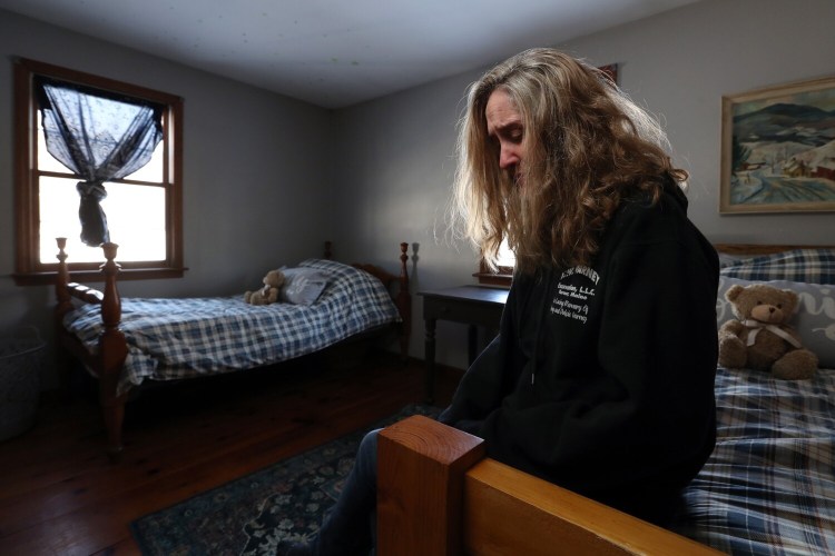 Tracy Blake-Bell tears up while sitting in the bedroom to be shared by two teenage Ukrainian brothers that she and her husband, Nat Bell, are trying to adopt. The couple visited Ukraine three weeks ago to sign adoption paperwork. They were supposed to return, but then war broke out. Now, they wait. And hope.